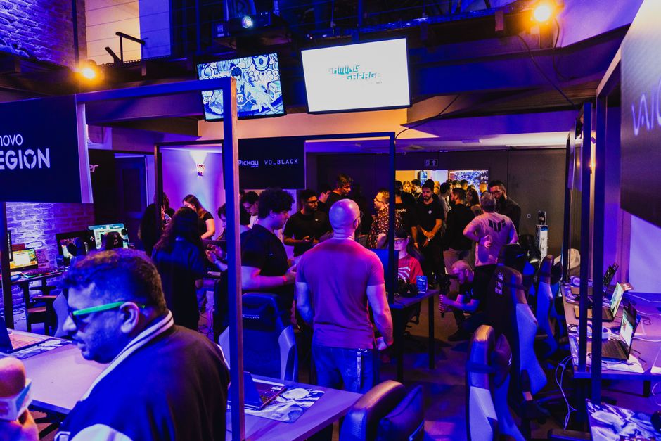 Vibrant arcade room filled with gamers participating in a competitive tournament under violet lighting.